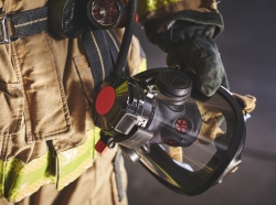 A firefighter holding an oxygen mask