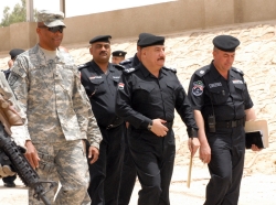 Iraqi Police and U.S. colonel attended the Iraqi Police River Patrol Graduation ceremonies on the banks of the Tigris River