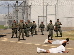 Guards move into the exercise yard near a general population cell block at Corcoran State Prison, California, October 1, 2013