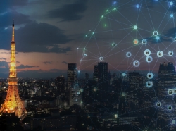 Cybersecurity locks illustration superimposed over a photo of Tokyo at night