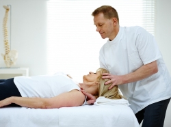 Chiropractor adjusting the neck of a female patient