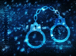 Cybercrime concept of handcuffs icon on a digital background, photo by blackboard/Adobe Stock