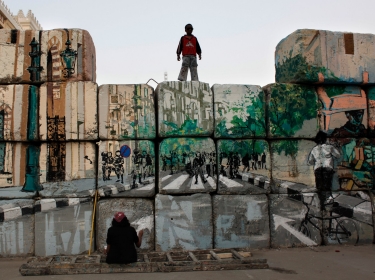 boy watching a graffiti artist in Cairo