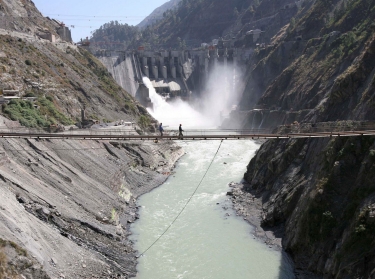 Laborers walk on a bridge near the 450-megawatt hydropower project at Baglihar Dam on the Chenab River which flows from Indian Kashmir into Pakistan, October 10, 2008, photo by Amit Gupta/Reuters
