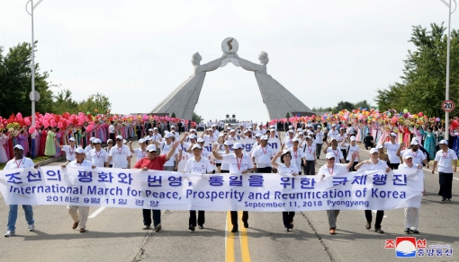 People attend a march for peace, prosperity, and reunification of Korea near the Arch of Reunification in Pyongyang, North Korea, in this undated photo released September 12, 2018 by the Korean Central News Agency