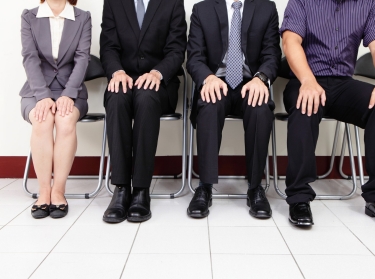 Four people waiting for a job interview
