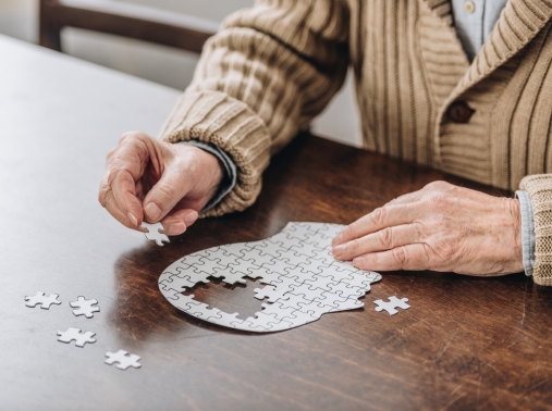 A senior man playing with a puzzle