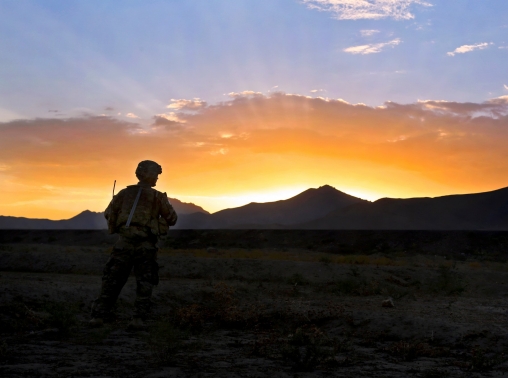 A depressed soldier looking out a window