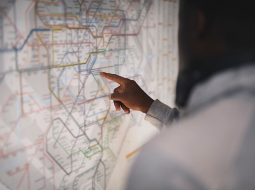 Person pointing at a public transit map