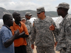 commander of JTF-Haiti asks a few Haitians about the living conditions at the internally displaced persons camp