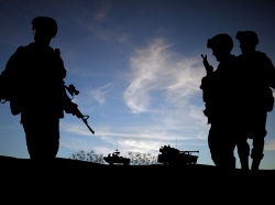 Silhouette of soldiers with military vehicles, photo by veneratio/Adobe Stock