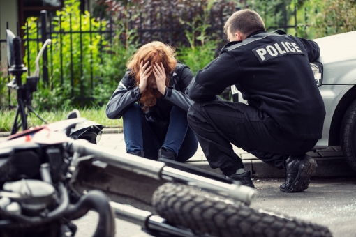 A policeman talks to a distressed person on the street