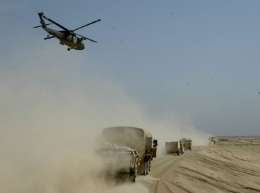 A U.S. Army medical helicopter flies over the Army's 3rd Infantry division's convoy on its push towards Baghdad, Iraq, April 3, 2003, photo by Kai Pfaffenbach/Reuters
