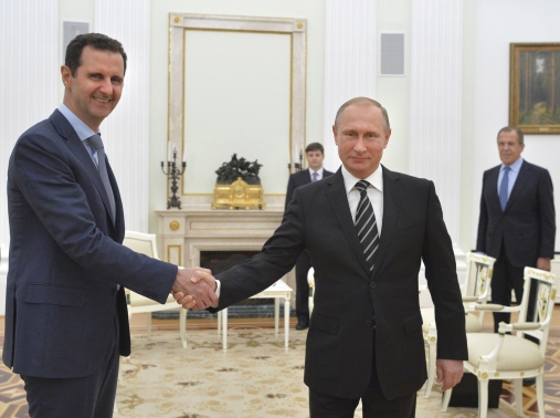 Russian President Vladimir Putin shakes hands with Syrian President Bashar al-Assad during a meeting at the Kremlin in Moscow, October 20, 2015