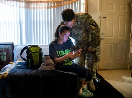 An Army couple reacts to local residents' posts regarding housing issues on a community Facebook group at their army base home in Fort Hood, Texas, May 16, 2019