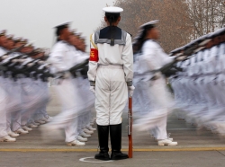 Chinese People's Liberation Army Navy recruits march during a parade in Qingdao, Shandong province, December 5, 2013