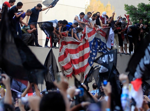 Protesters destroy an American flag pulled down from the U.S. embassy in Cairo, September 11, 2012