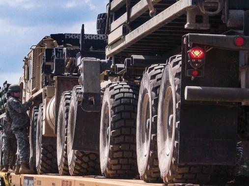 Members of the Iowa National Guard load vehicles during railhead operations at Camp Shelby, Mississippi