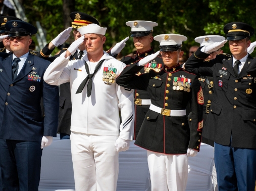 Servicemembers from all four military branches salute during the 50th Annual EOD Memorial Service, May 4, 2019