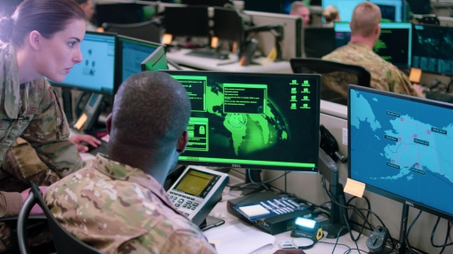 Capt. Sarah Miller and Tech. Sgt. Carrol Brewster discuss options in response to a staged cyber attack during filming of a scene for an AFRC mission video at Joint Base San Antonio-Lackland, Texas, June 1, 2019