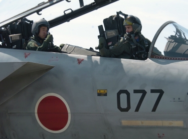 A U.S. pilot (right) gives a thumbs up to a Japanese pilot (left)