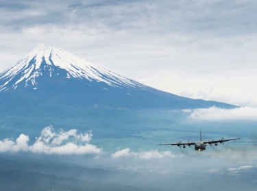 A formation of C-130 Hercules cargo aircraft fly in formation as they return from the Samurai Surge training mission near Mount Fuji, Japan, June 5, 2012
