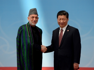 Afghanistan's President Hamid Karzai and his Chinese counterpart Xi Jinping shake hands before the opening ceremony of the fourth Conference on Interaction and Confidence Building Measures in Asia summit in Shanghai May 21, 2014