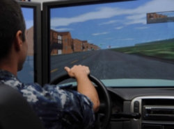 Intelligence Specialist Seaman drives a simulator during the Save a Life Tour
