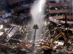 New York City firefighters pour water on the wreckage of 7 World Trade Center in Sept. 2001