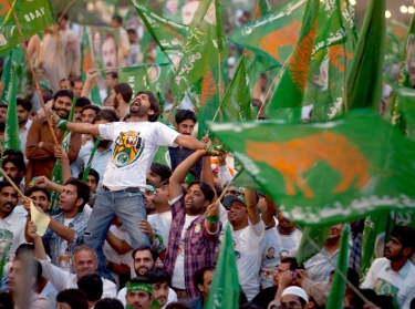 Supporters of the Pakistan Muslim League (N) party cheer their leader, Nawaz Sharif (not pictured), during a campaign rally in Islamabad, Pakistan, May 2013