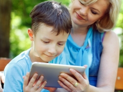 Little boy with tablet and mother