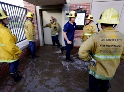 Los Angeles firefighters standing in a flood