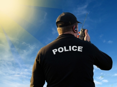 Police officer using radio to communicate