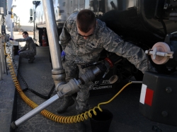 Senior Airmen Derek Wilson, foreground, and Noah Lazurka sample the fuel from a tank Feb. 11, 2015, at Seymour Johnson Air Force Base, N.C. Laboratory technicians test all fuel upon receipt, and at various other scheduled intervals. Wilson and Lazurka are both 4th Logistics Readiness Squadron fuels laboratory technicians