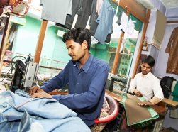 Two Indian men working in a textile shop
