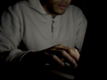 Man on laptop at night