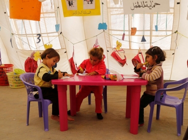 Syrian refugee children draw inside a makeshift school, supported by UNICEF and in cooperation with the Beyond Association, in Zahle, Lebanon, October 22, 2014