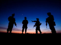 U.S. service members at a crossroads at dusk in Helmand Province, Afghanistan, December 2009