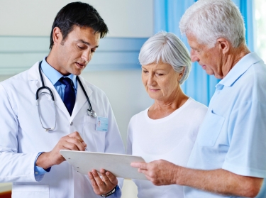 Doctor consulting with elderly patients