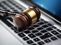 Gavel on laptop computer keyboard concept for online internet auction or legal assistance