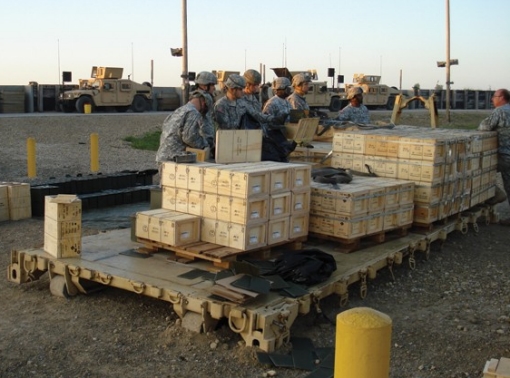Soldiers cross-check part of a 90-ton shipment of military supplies at Kabul International Airport, Afghanistan