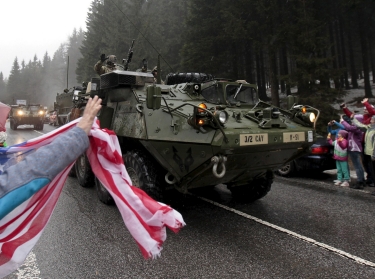 People welcome U.S. Army soldiers during a military exercise in Harrachov, Czech Republic