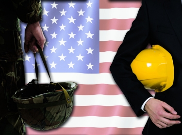 A soldier and a developer standing in front of an American flag