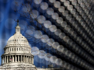 Light catches the security fence around the U.S. Capitol, erected in the wake of the January 6th attack but now scheduled to be removed, in Washington, D.C., March 15, 2021, photo by Jonathan Ernst/Reuters