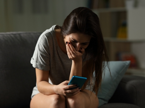 A woman shocked and upset by something on her phone