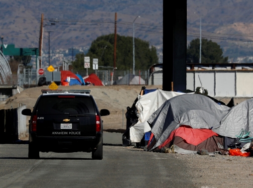 Police on patrol during what city officials call a slow and methodical clean-up and removal of a large homeless encampment in Anaheim, California, January 22, 2018