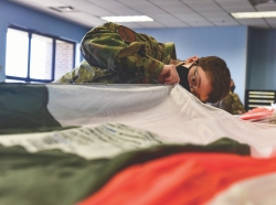 Senior Airman Brittany Arrasmith, 19th Operation Support Squadron Aircrew Flight Equipment technician, inspects a BA-30 parachute at Little Rock Air Force Base, Arkansas, Nov. 23, 2020. A handful of AFE Airmen, chosen based on their parachute rigging ability and experience, were sent to hands-on training for five days coordinated by Air Mobility Command to learn about the fundamentals, build up, inspection and repack of the low profile parachute, photo by Airman 1st Class Isaiah Miller/U.S. Air Force