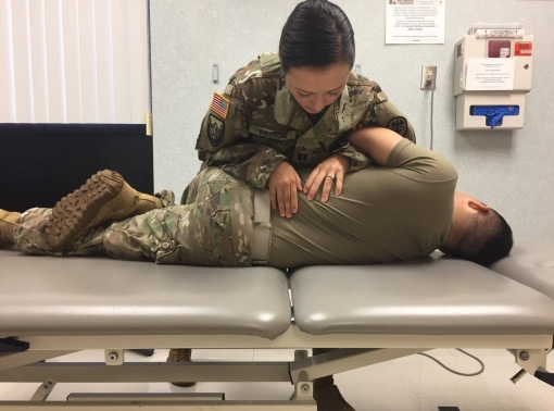 A service member being treated for lower back pain, photo by U.S. Army