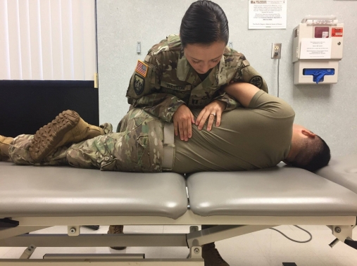 A service member being treated for lower back pain