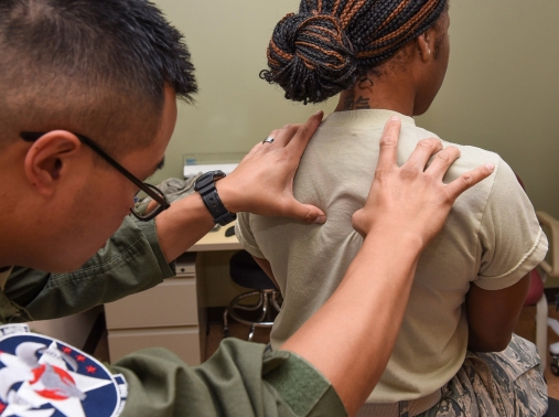 U.S. Air Force Maj. Lucky Lusterio performs a thoracic spine mobility test on Staff Sgt. Shaniqua Anderson at Wright-Patterson Air Force Base, Ohio, September 21, 2017